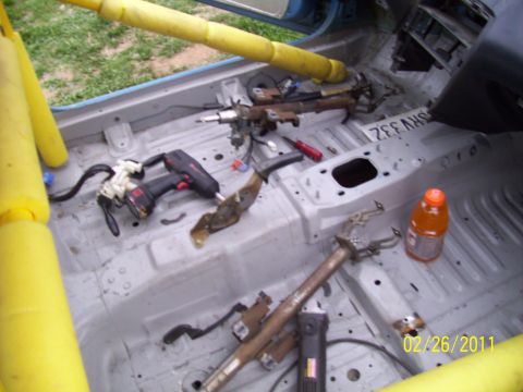 1995 Ford Probe - The interior of a car is shown disassembled, with tools and parts scattered on the floor.
