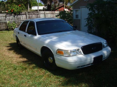 2002 Ford Crown Victoria - White 2002 Ford Crown Victoria with tinted windows parked outdoors.