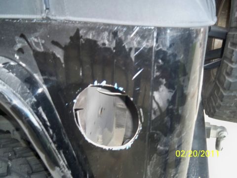1992 Jeep Wrangler - Rear quarter panel of a 1992 Jeep Wrangler showing a hole cut for modification.