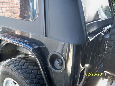 1992 Jeep Wrangler - Rear view of a 1992 Jeep Wrangler showing the fuel filler door and tire.