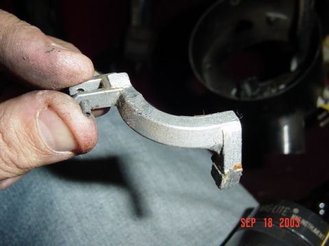 1989 Ford Bronco - A close-up shows a metal bracket being held by fingers, with a date stamp of "SEP 18 2003" visible in the lower right corner.