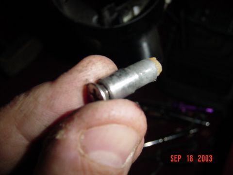 1989 Ford Bronco - A close-up shows a metal part with a frayed end being held by fingers, with a date stamp of SEP 18 2003 visible.
