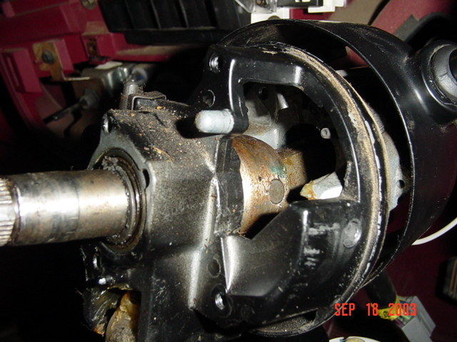 Disassembled steering column with exposed splined shaft and greasy housing