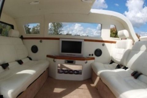 1981 Ford Bronco - Interior view of a custom limousine with multiple rows of seating and an entertainment system.