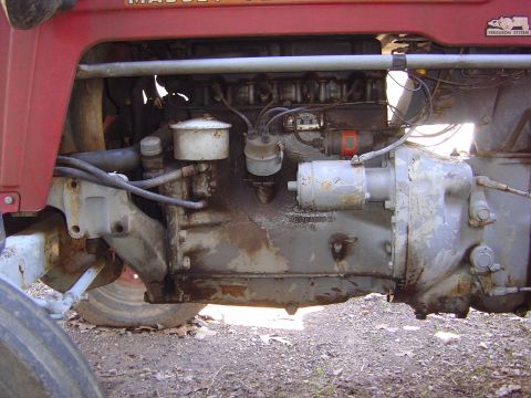 1986 Ford Bronco - Close-up view of a weathered tractor engine, revealing mechanical components and signs of age.