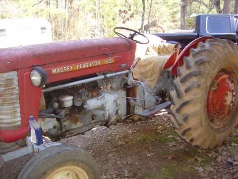 1986 Ford Bronco - A red Massey-Ferguson 65 tractor sits outdoors with a pickup truck visible in the background.