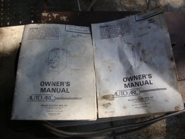 Two Miller Electric Auto Arc owner's manuals, one showing a diagram of a welder, the other showing a welding gun