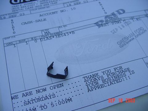 1989 Ford Bronco - A dark metal clip rests on a Ford parts receipt from Gresham, Oregon, dated September 18, 2003.