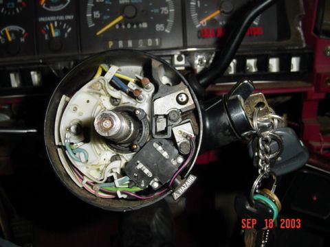 1989 Ford Bronco - The ignition switch assembly and dashboard gauges of a 1989 Ford Bronco are visible.
