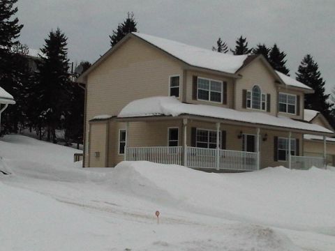 1984 Ford Bronco - A house sits under a blanket of snow during winter.