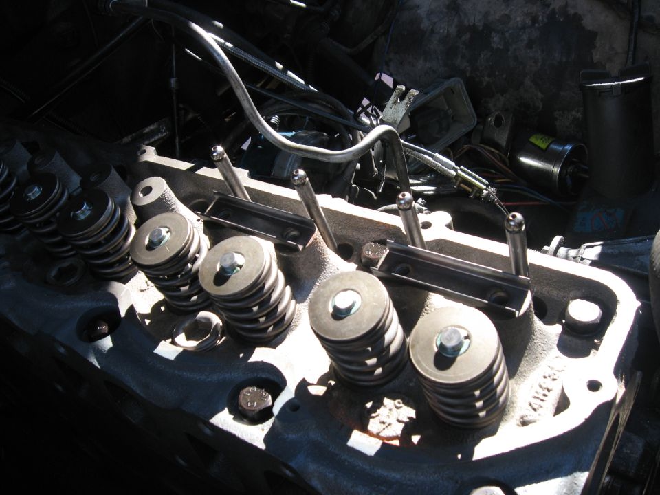 Engine cylinder head with valve springs and pushrods visible