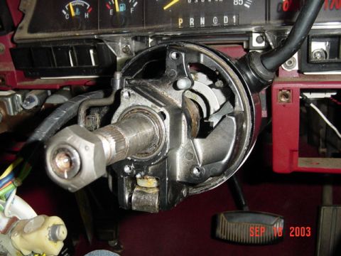 1989 Ford Bronco - Close-up of a vehicle's steering column ignition switch mechanism, with a visible date stamp of September 16, 2003.