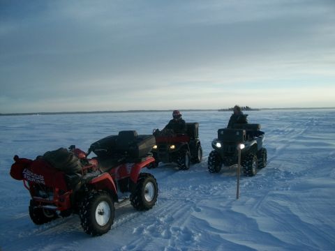 1986 Chevrolet Blazer - Riders on ATVs traverse a frozen landscape under a vast, overcast sky.