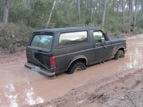 1990 Ford Bronco - This 1990 Ford Bronco is stuck deep in the mud on an off-road trail.