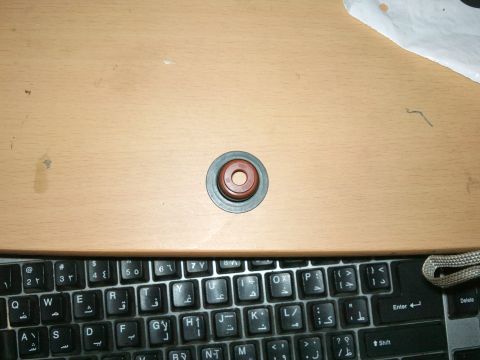 1998 Ford Crown Victoria - A single Fel-Pro valve seal, part number SS 72891, is shown on a wooden surface above a keyboard.