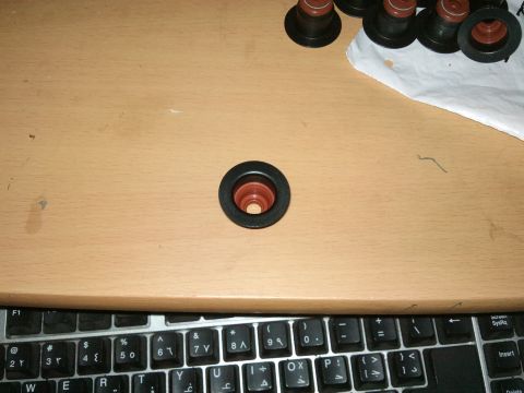 1998 Ford Crown Victoria - Close-up of valve seals on a desk next to a keyboard.