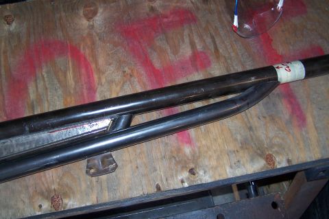 2000 Ford F-150 - Metal tubing with markings and tape is laid out on a wooden surface, possibly for a project.