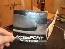 1996 Ford Bronco - A manual for the Nissan/Infiniti AccessPORT is held by a hand.