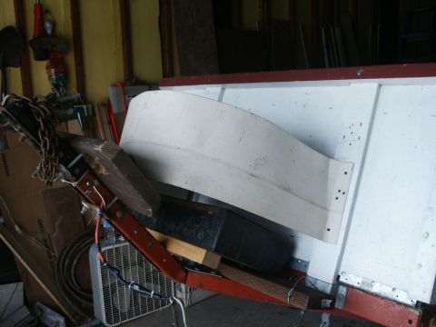 1990 Ford Bronco - A cluttered scene shows a trailer frame with various items attached, including chains and a fan.