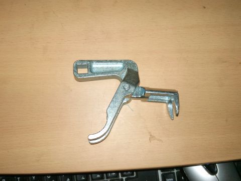 1998 Ford Crown Victoria - A valve spring compressor tool is shown against a wooden background, with a keyboard partially visible at the bottom.