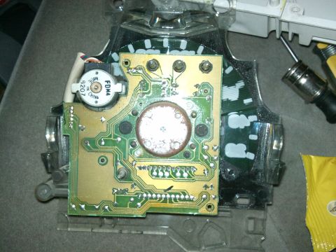 1998 Ford Crown Victoria - Close-up view of an instrument cluster circuit board, showing a motor and various electronic components.
