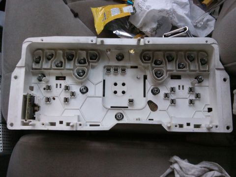 1998 Ford Crown Victoria - The rear of a car's instrument cluster, showing the sockets for bulbs and electrical connections.