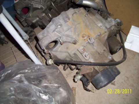 1995 Ford Probe - Close-up of a car transmission part, likely removed from a vehicle for repair or replacement.