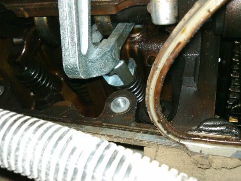 1998 Ford Crown Victoria - Valve spring compressor tool in use on an engine valve spring.