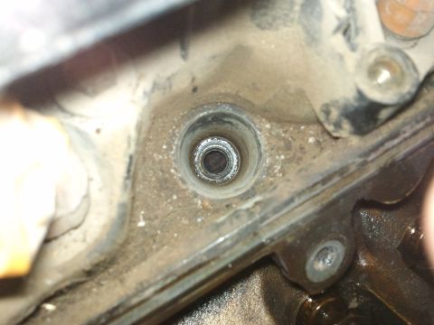 1998 Ford Crown Victoria - A close-up view of an engine's cylinder bore, showing internal threads and the surrounding metal components.