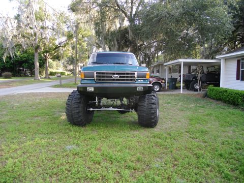 1978 Ford Bronco - This lifted Ford truck features oversized tires and a prominent grille, suggesting a model from the early 1980s.