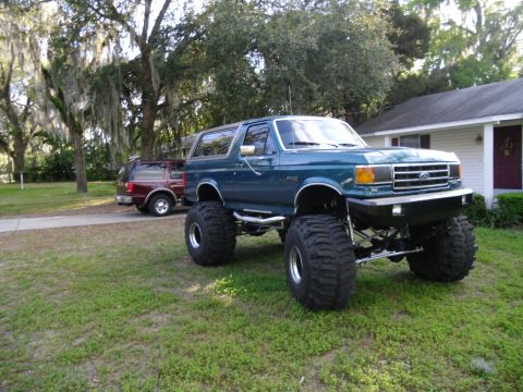 1978 Ford Bronco - This lifted Ford Bronco is parked in front of a house with a second SUV in the background.