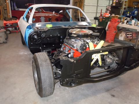 1972 Chevrolet Camaro - Front end of a 1970 Chevrolet Camaro in a workshop, engine installed, body in primer.