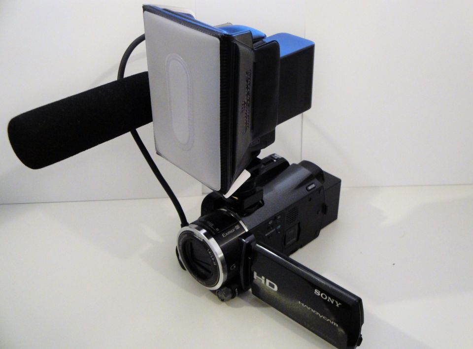 Black Sony Handycam camcorder with attached microphone and LED light panel