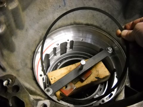 1993 Ford C-150 (Centurion Conversions) - Transmission drum assembly with a tool holding a snap ring during a rebuild process.