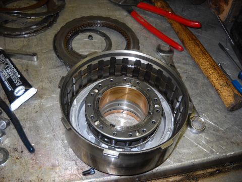 1993 Ford C-150 (Centurion Conversions) - A close-up view of a disassembled automatic transmission drum, showing internal components and surrounding tools.