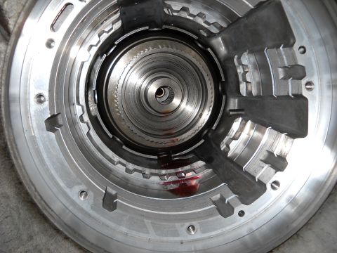 1993 Ford C-150 (Centurion Conversions) - Internal components of a transmission are shown after disassembly, revealing intricate metal parts.