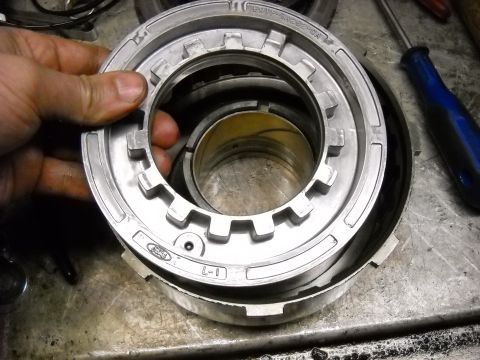 1993 Ford C-150 (Centurion Conversions) - A Ford transmission clutch pack component is held for inspection, showing part numbers.