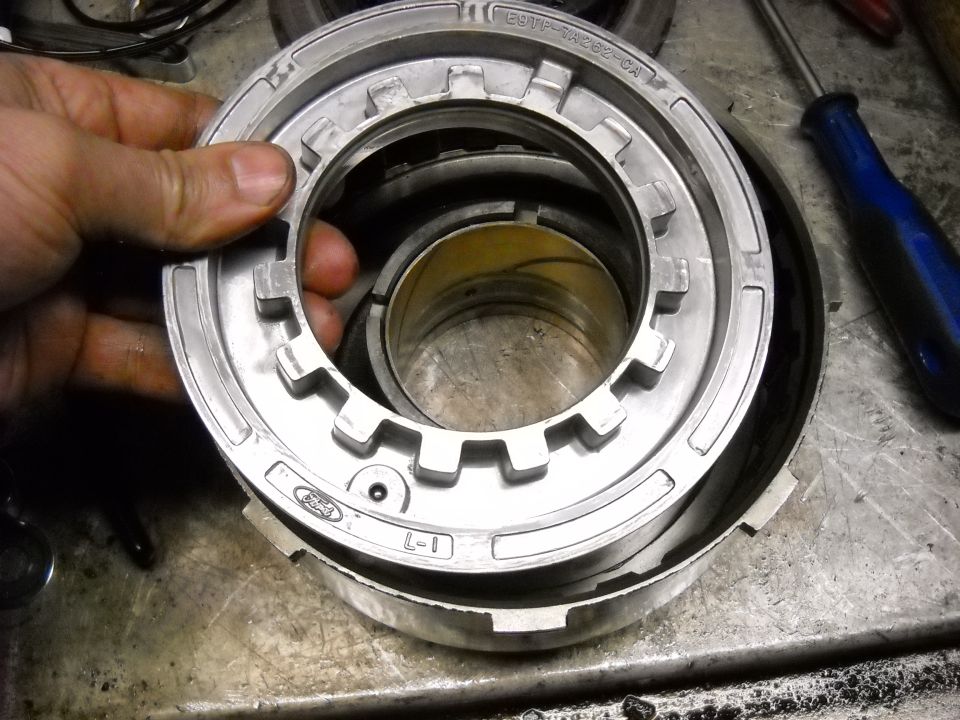 Close-up of a Ford transmission clutch pack component with part numbers visible