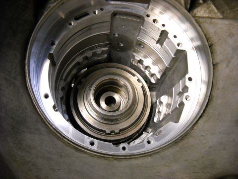 1993 Ford C-150 (Centurion Conversions) - Close-up view of the internal components of an automatic transmission torque converter housing, likely during a rebuild process.