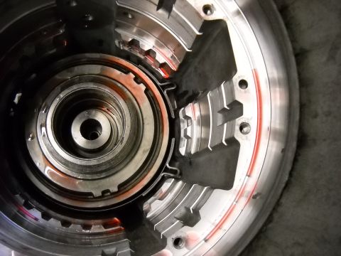 1993 Ford C-150 (Centurion Conversions) - Internal components of a torque converter, with visible gears and traces of transmission fluid.