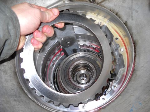 1993 Ford C-150 (Centurion Conversions) - Close-up of a transmission clutch pack being serviced, showing internal components.