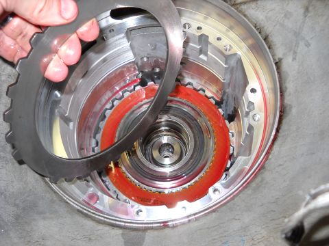 1993 Ford C-150 (Centurion Conversions) - Close-up view of an automatic transmission clutch pack, showing friction plates and internal components during a rebuild.