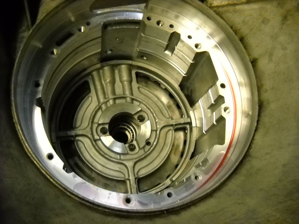 Metal transmission torque converter housing with internal fins and bolt holes