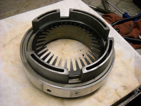 1993 Ford C-150 (Centurion Conversions) - A metal component, likely from a transmission, is shown with intricate internal fins and a segmented outer ring.