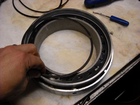 1993 Ford C-150 (Centurion Conversions) - Close-up of a transmission component being handled, with tools nearby.