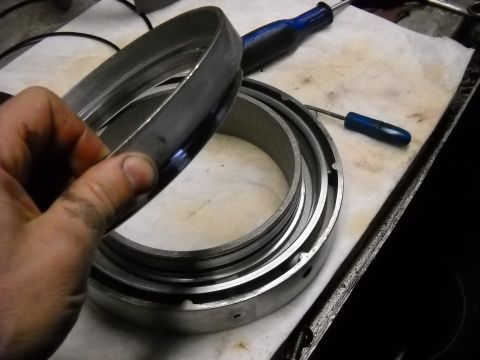 1993 Ford C-150 (Centurion Conversions) - Metal rings and screwdrivers are laid out on a white cloth, suggesting mechanical work.