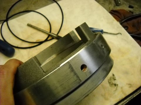 1993 Ford C-150 (Centurion Conversions) - Close-up of a metal transmission component, possibly for an E4OD rebuild, with visible machining marks.