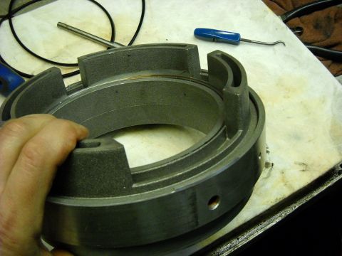 1993 Ford C-150 (Centurion Conversions) - Close-up of a metal transmission component, likely for an E4OD rebuild, with tools nearby.