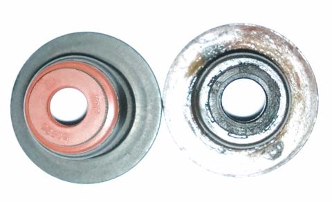 1998 Ford Crown Victoria - Comparison of a new valve seal next to a used and corroded one.