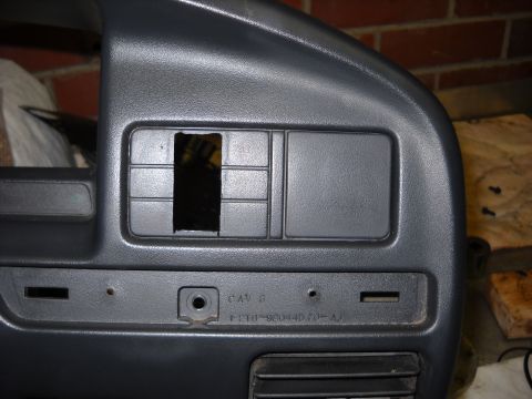 1993 Ford C-150 (Centurion Conversions) - Close-up of a gray dashboard panel, showing a cut-out section and part number F2TB-98044D70-AJ.